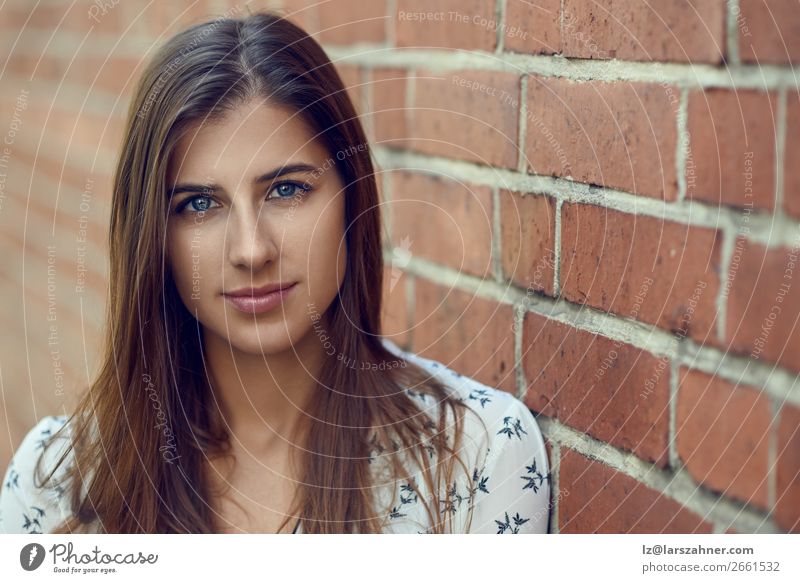 Portrait of young pretty woman near brick wall Lifestyle Joy Happy Beautiful Face Woman Adults 1 Human being 18 - 30 years Youth (Young adults) Nature Autumn