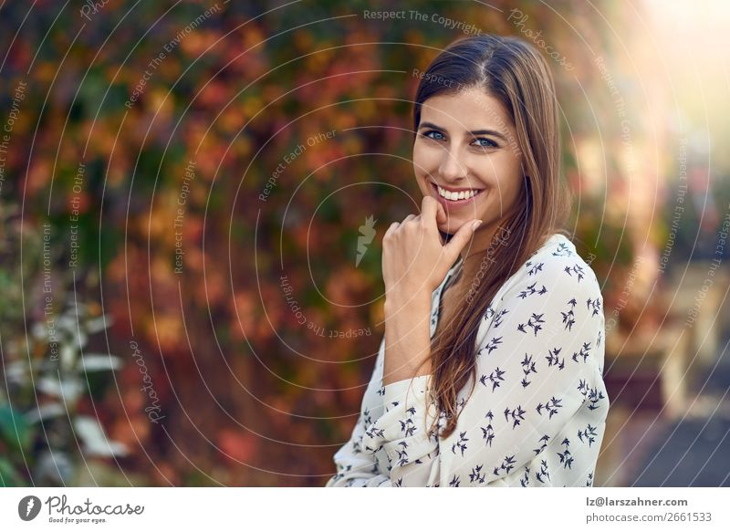 Attractive young woman in a colorful fall street Happy Woman Adults 1 Human being 18 - 30 years Youth (Young adults) Autumn Leaf Street Fashion Brunette Smiling