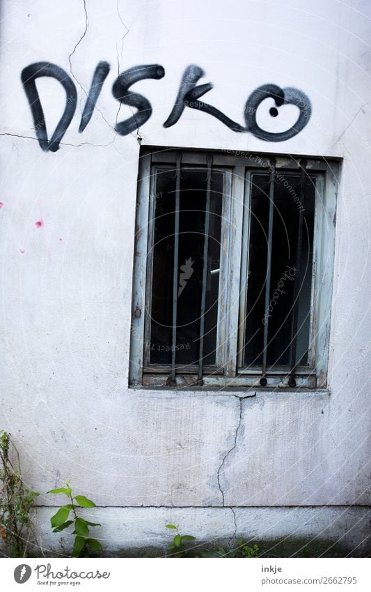 dive Deserted Wall (barrier) Wall (building) Facade Window Grating Concrete Characters Graffiti Threat Dark Hideous Cold Disco Black Gray Gloomy Colour photo