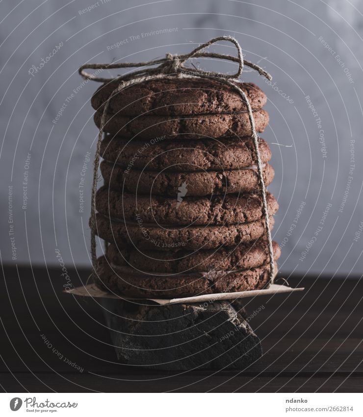 stack of round chocolate cookies tied with a rope Cake Dessert Candy Nutrition Table Rope Group Eating Dark Delicious Brown background Baking biscuit food