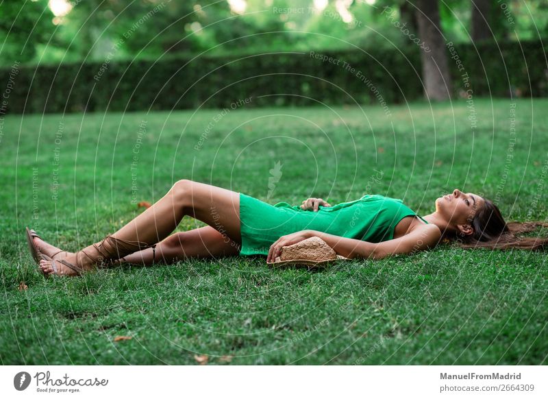 young cheerful woman lying down on the grass Lifestyle Happy Beautiful Leisure and hobbies Summer Human being Woman Adults Nature Grass Park Meadow Smiling
