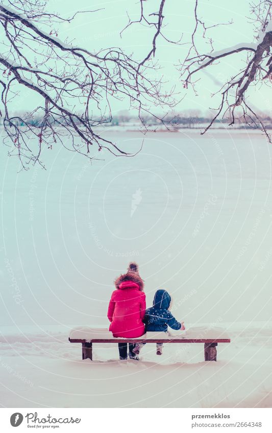 Mother and her daughter sitting on a bench on wintery day Lifestyle Joy Happy Winter Snow Winter vacation Human being Child Toddler Girl Young woman