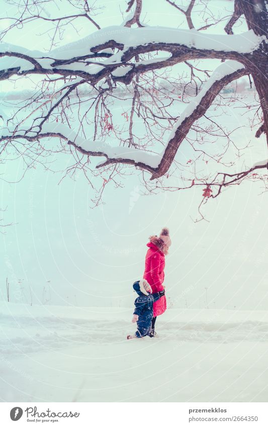 Mother and her daughter are spending time outdoors in winter Lifestyle Joy Happy Winter Snow Winter vacation Human being Child Toddler Girl Young woman