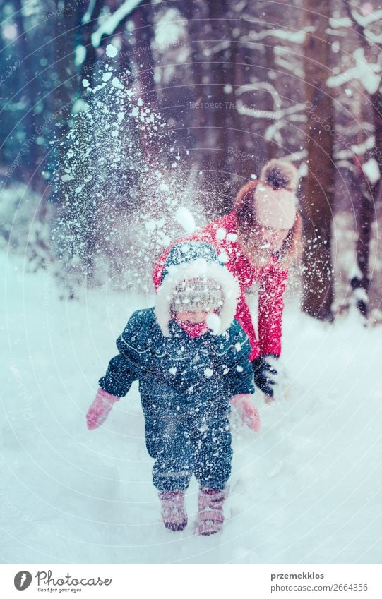 Little girl with winter clothes going through deep snow in park outdoor  Stock Photo - Alamy