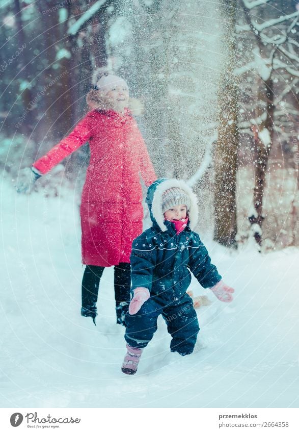 Mother is playing with her little daughter outdoors in winter Lifestyle Joy Happy Winter Snow Winter vacation Human being Child Toddler Girl Young woman