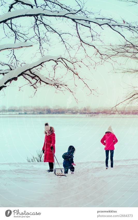 Little girl with winter clothes going through deep snow in park outdoor  Stock Photo - Alamy