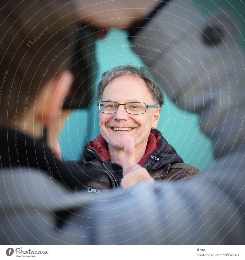 flip book Camera Masculine Man Adults 2 Human being Wall (barrier) Wall (building) Jacket Eyeglasses brunette Short-haired Thumb smile Laughter Joy Contentment