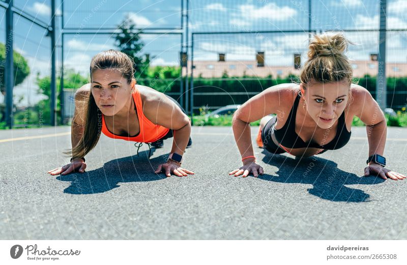 Sportswomen doing push-ups Lifestyle Beautiful Personal hygiene Human being Woman Adults Friendship Brunette Blonde Fitness Athletic Strong Power Effort Energy