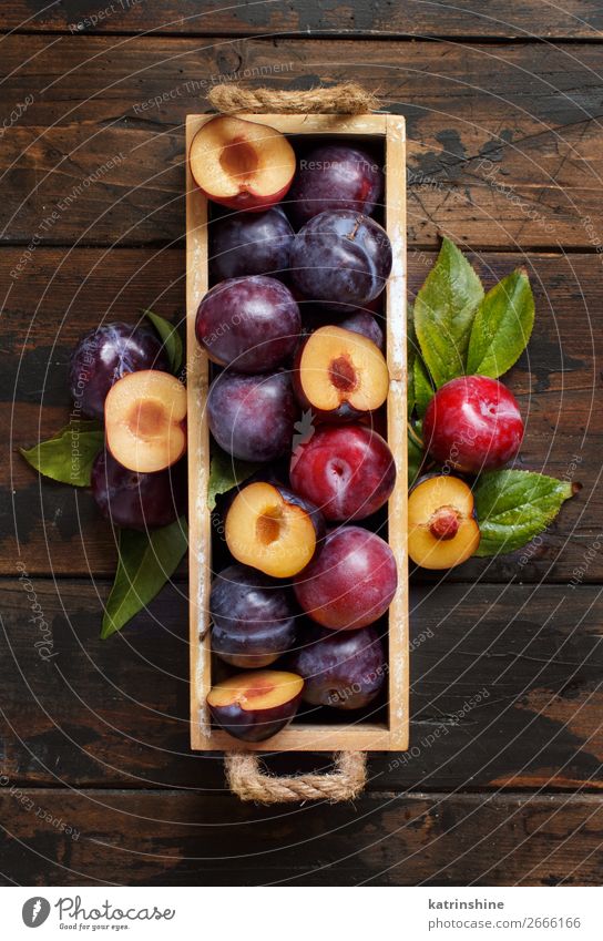 Fresh plums with leaves Stock Photo by katrinshine