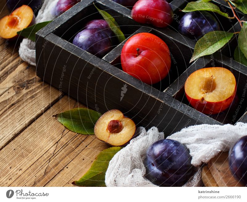 Fresh plums with leaves Fruit Nutrition Vegetarian diet Diet Bowl Summer Table Autumn Leaf Wood Juicy Brown Plum Purple Raw Mature agriculture sweet vitamins