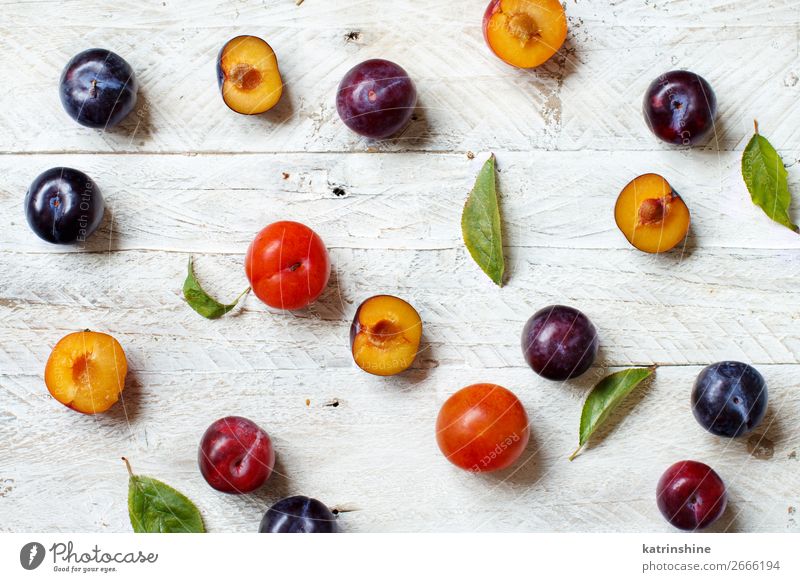 Fresh plums with leaves Stock Photo by katrinshine