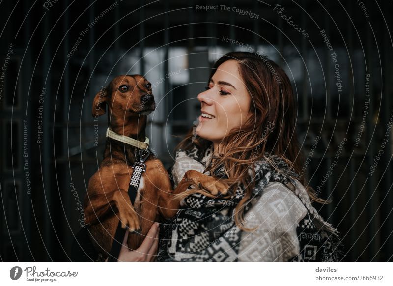White smiling girl holing her dog in the arms Lifestyle Joy Young woman Youth (Young adults) Woman Adults Friendship 1 Human being 30 - 45 years Town Scarf
