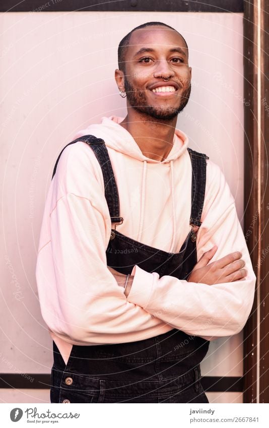 Young black man wearing casual clothes smiling against pink urban background Lifestyle Happy Beautiful Human being Masculine Young man Youth (Young adults) Man