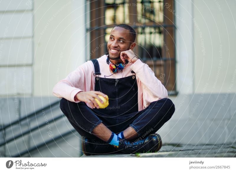 Young black man eating an apple sitting on urban steps Fruit Apple Eating Lifestyle Happy Beautiful Human being Masculine Young man Youth (Young adults) Man