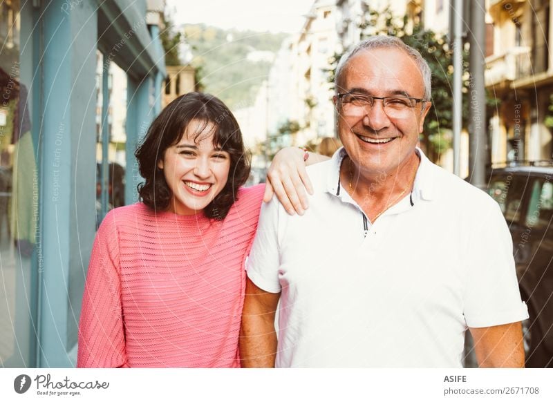 Father and daughter laughing together Joy Happy Beautiful Woman Adults Man Parents Family & Relations Street Eyeglasses Smiling Laughter Love Happiness Together