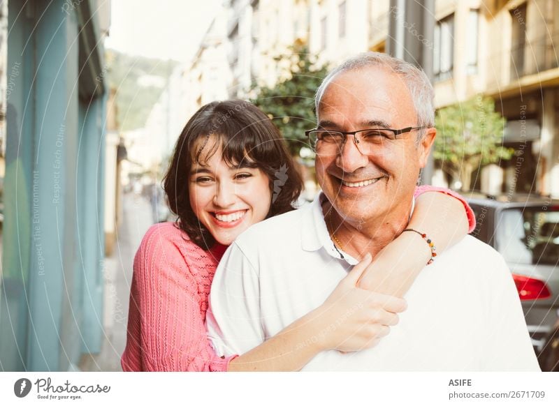 Portrait of happy father and daughter embracing on the street Joy Happy Beautiful Woman Adults Man Parents Father Family & Relations Street Eyeglasses Smiling