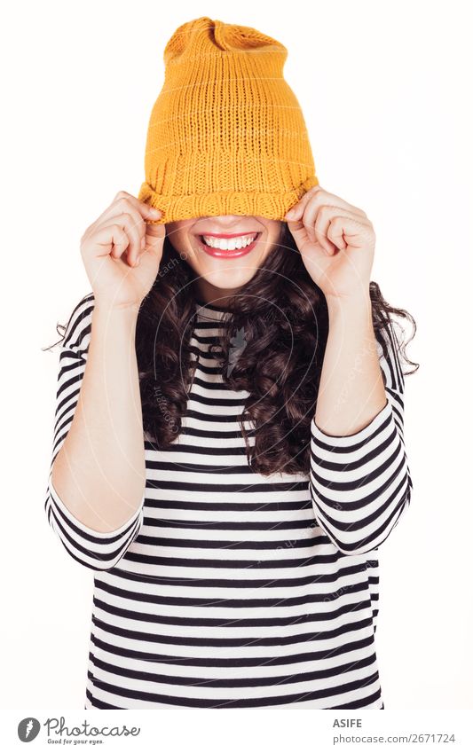 Happy autumn or winter girl covering face with wool cap Beautiful Winter Woman Adults Teeth Autumn Dress Smiling Happiness Funny Yellow Black White Wool