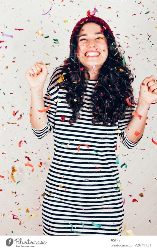Laughing girl with striped dress and wool cap under a rain of confetti Joy Happy Beautiful Feasts & Celebrations Birthday Woman Adults Brunette Smiling Laughter