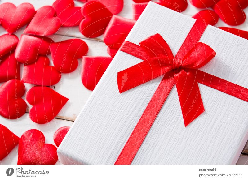 Red hearts and gift box on white wooden background. Heart Pattern Gift Present Day Neutral Background Love Valentine's Day Romance Vacation & Travel