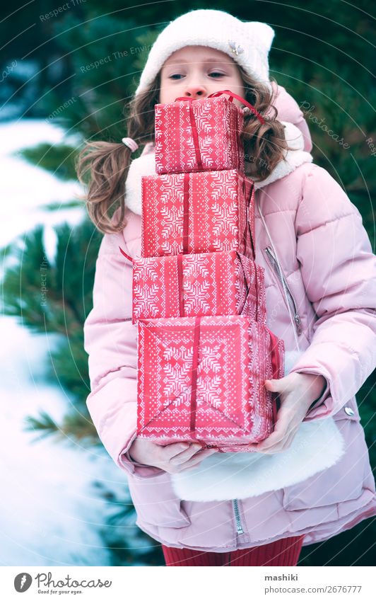 happy kid girl playing outdoor with christmas gifts Lifestyle Joy Happy Playing Vacation & Travel Winter Snow Feasts & Celebrations Christmas & Advent Child