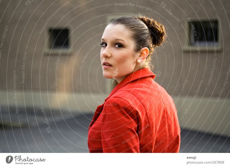Caught Feminine Young woman Youth (Young adults) 1 Human being Beautiful Red Jacket Chignon Surprise Colour photo Exterior shot Copy Space left Day Light