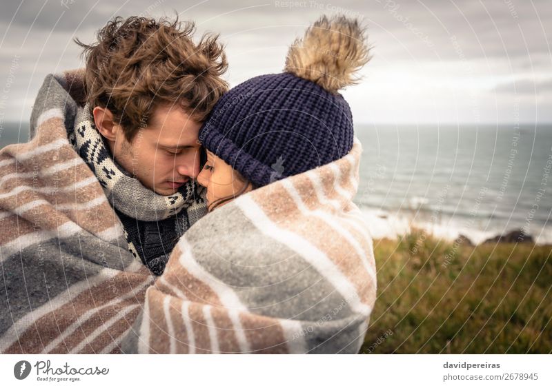 Young couple embracing outdoors under blanket in a cold day Lifestyle Happy Beautiful Ocean Winter Mountain Woman Adults Man Couple Nature Sky Clouds Autumn
