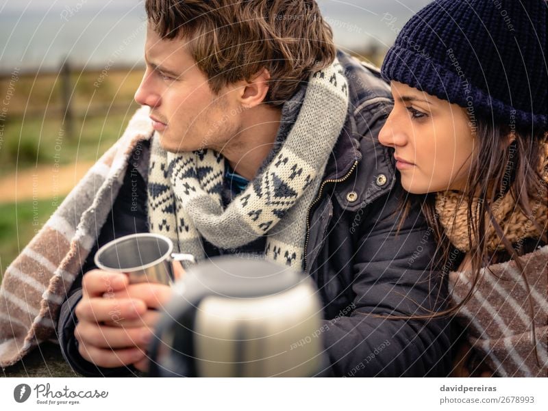 Couple under blanket having hot beverage in a cold day Beverage Coffee Tea Lifestyle Happy Winter Table Woman Adults Man Hand Nature Sky Clouds Autumn Wind