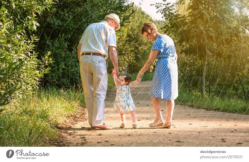 Grandparents and baby grandchild walking on nature path Lifestyle Happy Summer Child Human being Baby Woman Adults Man Grandfather Grandmother
