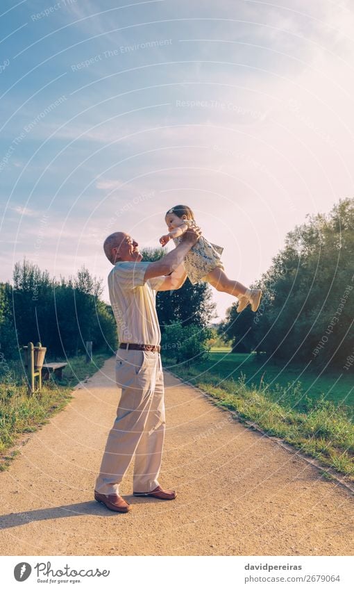 Senior man playing with baby girl Lifestyle Happy Relaxation Leisure and hobbies Playing Summer Human being Baby Toddler Woman Adults Man Parents Grandfather