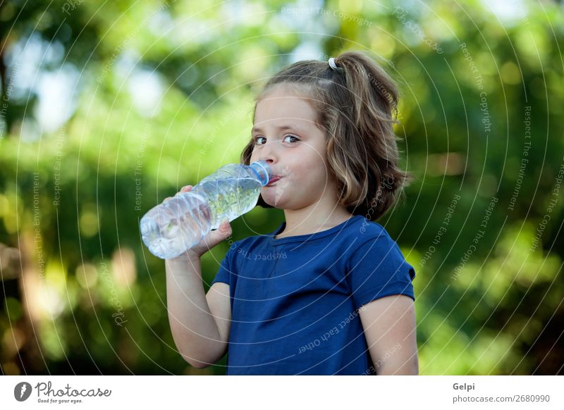 Cute little girl with water bottle Beverage Bottle Lifestyle Happy Beautiful Leisure and hobbies Summer Child Human being Woman Adults Infancy Hand Nature Park