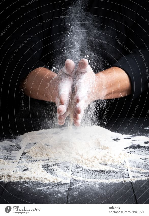 man's hands and splash of white wheat flour Dough Baked goods Bread Table Kitchen Human being Hand 30 - 45 years Adults Wood Make Dark Black White Bakery board