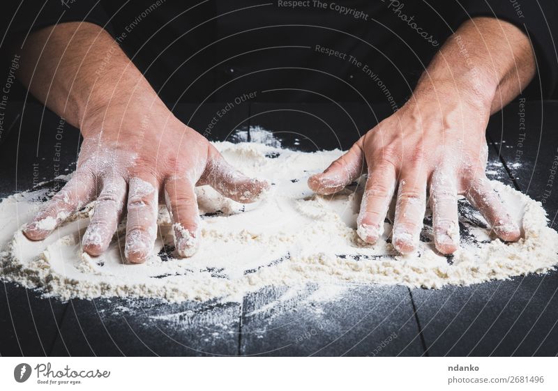 white wheat flour on a black wooden table Dough Baked goods Bread Table Kitchen Cook Human being Man Adults Hand Wood Make Dark Black White Flour chef Pizza