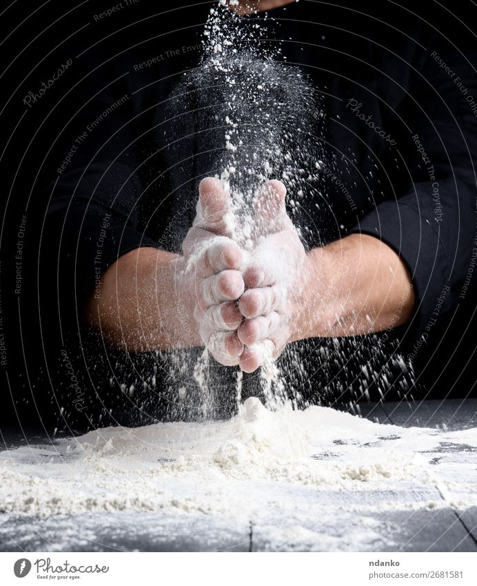 man's hands and splash of white wheat flour Dough Baked goods Bread Table Kitchen Cook Human being Hand Wood Make Dark Black White Splash Flour Pizza Bakery
