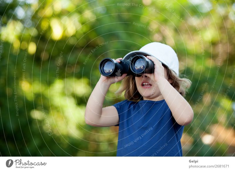 Little cute girl with a cap in the park looking by binoculars Joy Happy Beautiful Face Life Leisure and hobbies Vacation & Travel Camping Summer Child