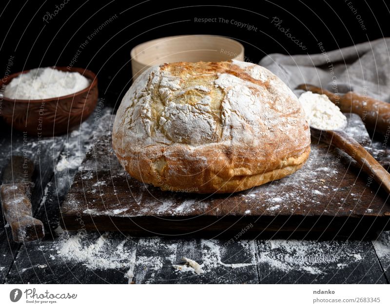 baked round white wheat bread Dough Baked goods Bread Bowl Spoon Table Kitchen Sieve Wood Make Dark Fresh Brown Black White Tradition Chopping board cooking