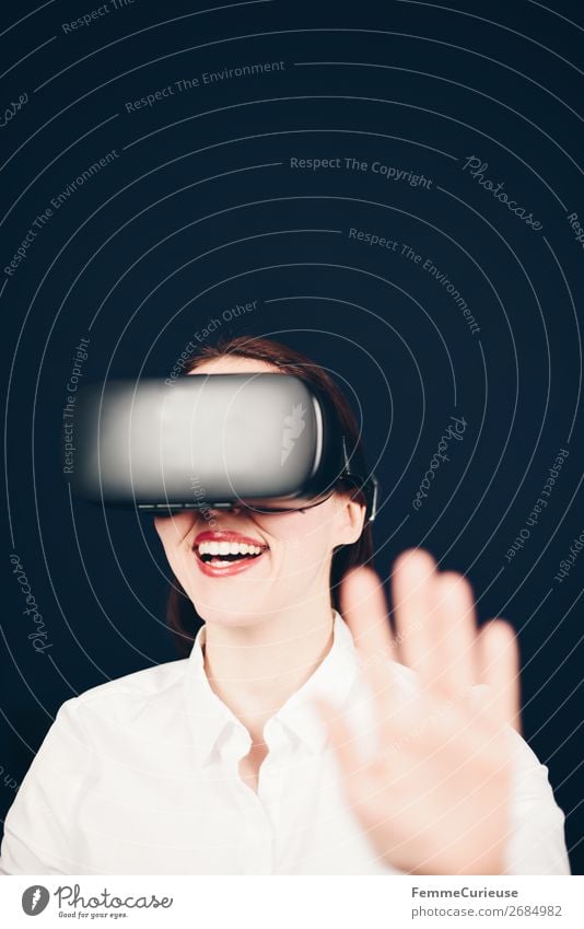 Smiling laughing woman with VR glasses and white blouse on neutral dark background Lifestyle Leisure and hobbies Technology Entertainment electronics