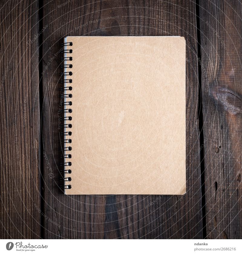 notebook on a black iron spring with brown sheets School Business Book Paper Wood Brown Idea background Blank Conceptual design Copy Space Diary education empty