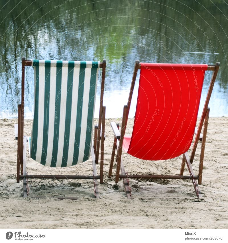 Two alone Relaxation Calm Vacation & Travel Tourism Summer Summer vacation Sunbathing Beach Lake Red Couch Deckchair Striped Empty Vantage point 2 Colour photo