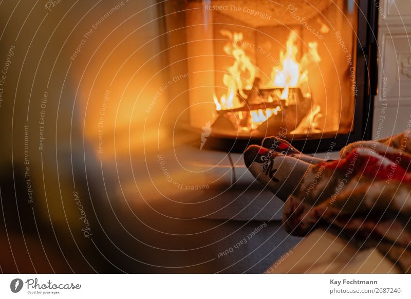 feet warming up on fireplace - a Royalty Free Stock Photo from