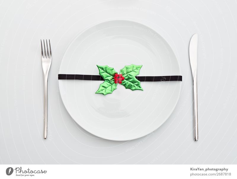 Christmas decoration with holly leaves on white plate Dinner Plate Cutlery Fork Decoration Restaurant Feasts & Celebrations Christmas & Advent New Year's Eve