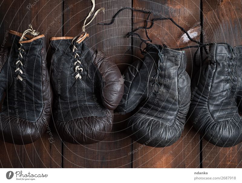 two pairs of leather old boxing gloves Sports Leather Accessory Gloves Wood Old Fitness Dark Retro Brown Black Protection Competition Action Ancient Antique