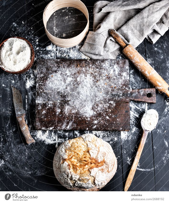 baked bread, white wheat flour, wooden rolling pin Dough Baked goods Bread Bowl Knives Spoon Table Kitchen Sieve Wood Make Dark Fresh Above Brown Black White