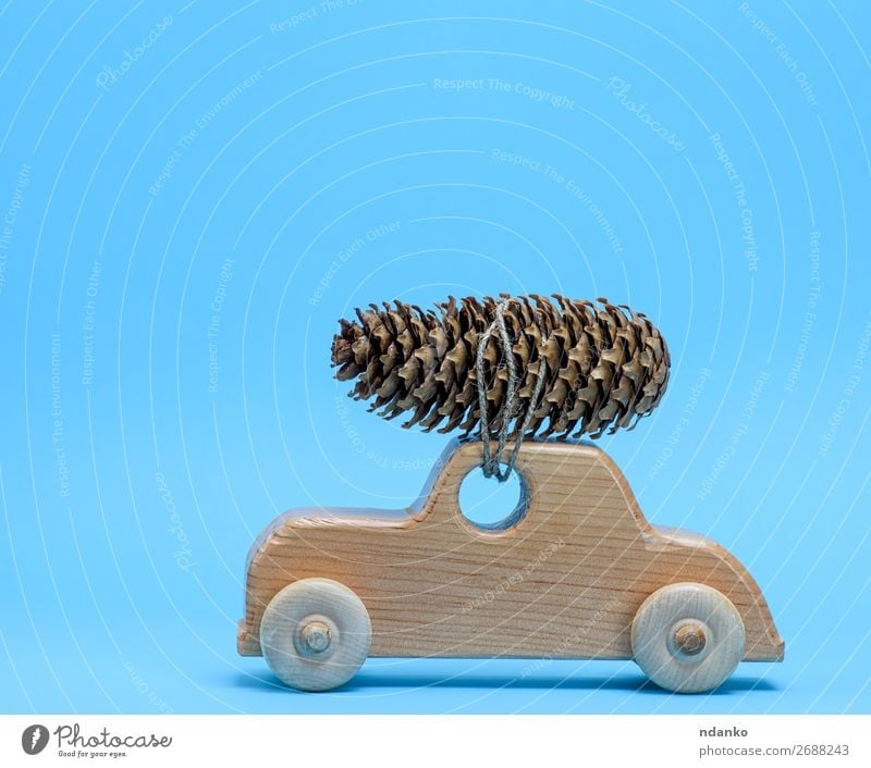 wooden toy car carries on top a pine cone Decoration Feasts & Celebrations Christmas & Advent New Year's Eve Transport Car Toys Wood Movement Retro Blue Brown