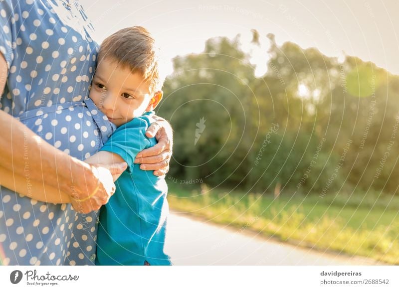Happy grandson hugging to his grandmother outdoors Lifestyle Relaxation Leisure and hobbies Summer Garden Child Human being Boy (child) Woman Adults Man Parents