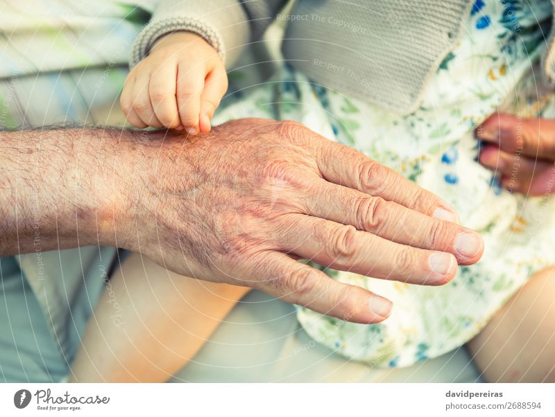 Baby girl touching hand of senior man Skin Life Child Retirement Human being Woman Adults Man Parents Father Grandfather Family & Relations Hand Fingers Old
