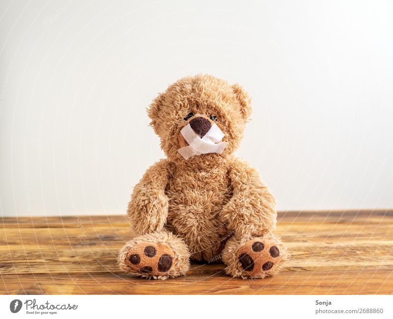 Teddy bear with mouth taped shut Adhesive plaster Sign Sit Cry Emotions Truth Honest Integrity Fairness Sadness Concern Pain Disappointment Loneliness Guilty