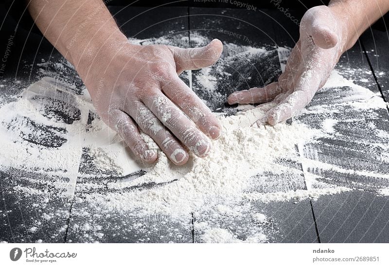 white wheat flour on a black wooden table Dough Baked goods Bread Kitchen Cook Human being Man Adults Hand Wood Make Dark Fresh Black White Baker Bakery Baking