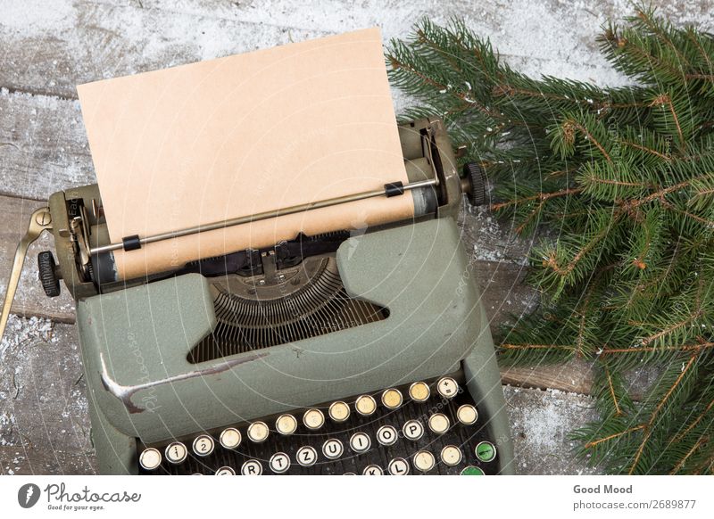 workplace with a typewriter and spruce branches on wooden table Winter Snow Feasts & Celebrations Christmas & Advent Workplace Office Business Technology Tree