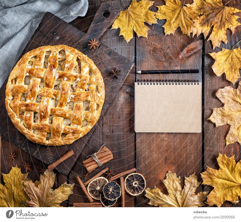 baked whole round apple pie on a brown wooden board Fruit Apple Cake Dessert Table Kitchen Autumn Leaf Wood Fresh Brown Yellow Tradition Pencil American Baking