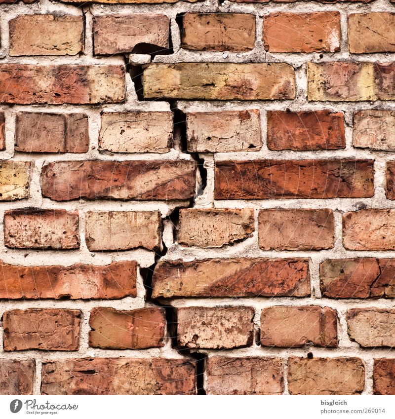 cracked wall Wall (barrier) Wall (building) Brick Brick construction Stone Red dissension crack in the wall Colour photo Exterior shot Deserted Day